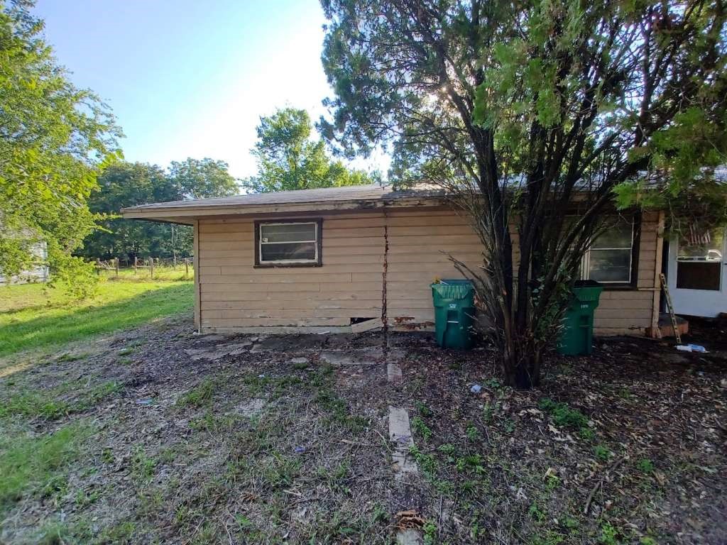 617 Grayson Street Pottsboro, TX 75076 - Photo 5 of 6 a backyard of a house with plants and large tree
