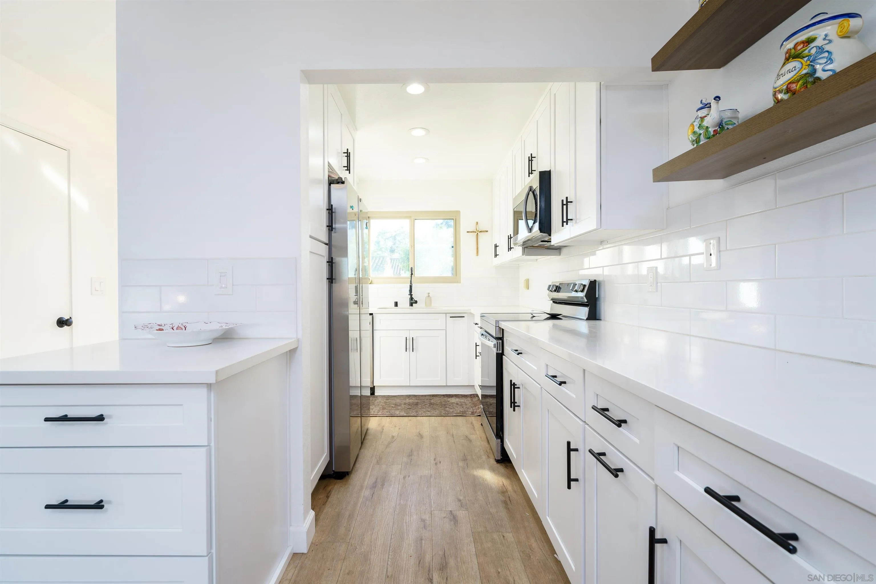 346 Abington Road Encinitas, CA 92024 - Photo 18 of 33 a kitchen with granite countertop white cabinets and white appliances