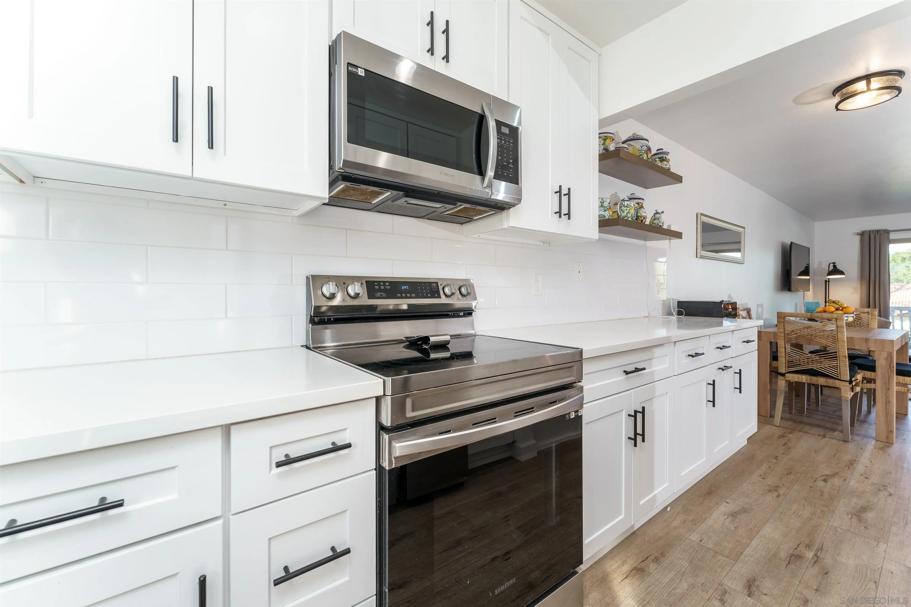 346 Abington Road Encinitas, CA 92024 - Photo 20 of 33 a kitchen with stainless steel appliances white cabinets and a stove top oven