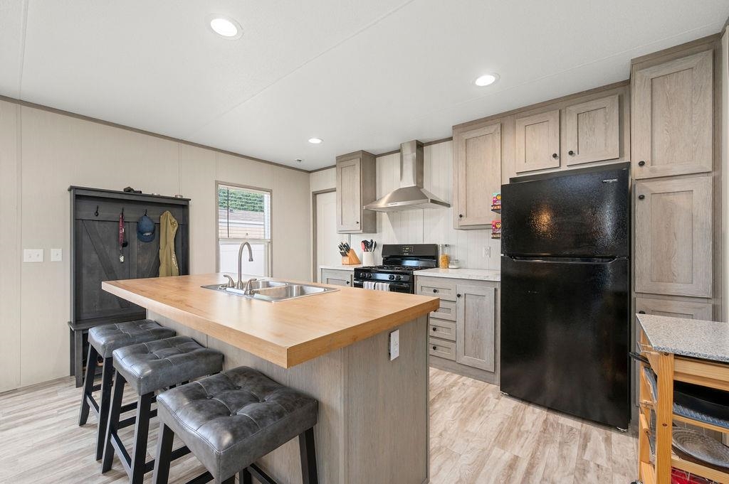 271 Clements Way Fruita, CO 81521 - Photo 7 of 26 a kitchen with a refrigerator a stove and a dining table