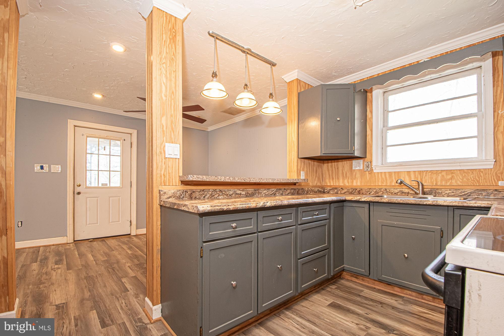 4792 Howellsville Road Front Royal, VA 22630 - Photo 16 of 41 a kitchen with a sink cabinets and wooden floor