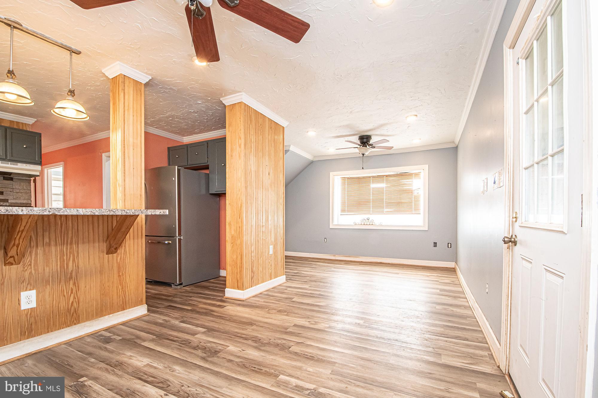 4792 Howellsville Road Front Royal, VA 22630 - Photo 17 of 41 a view of an empty room with wooden floor and a window