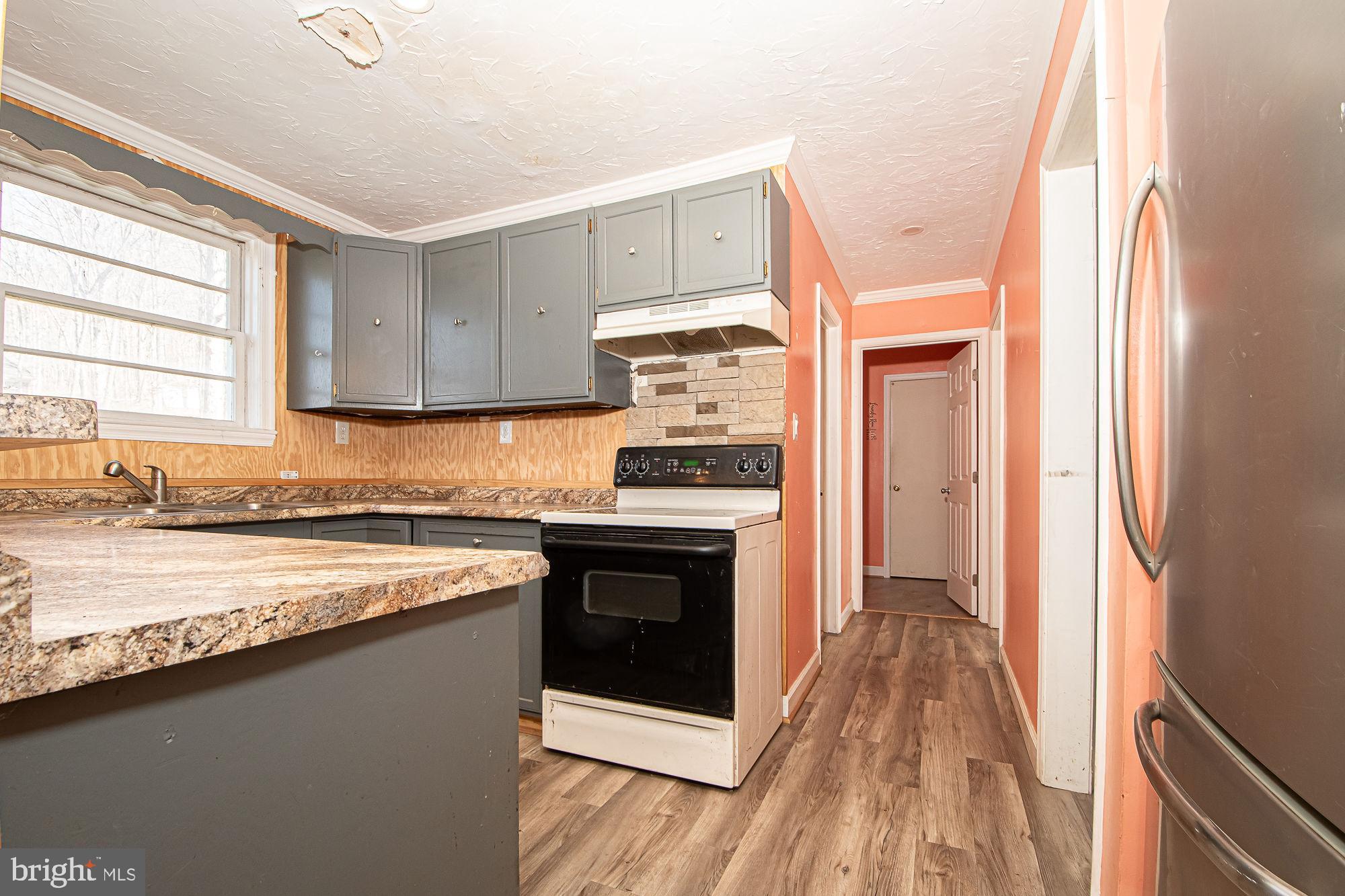 4792 Howellsville Road Front Royal, VA 22630 - Photo 21 of 41 a kitchen with a sink stove and refrigerator