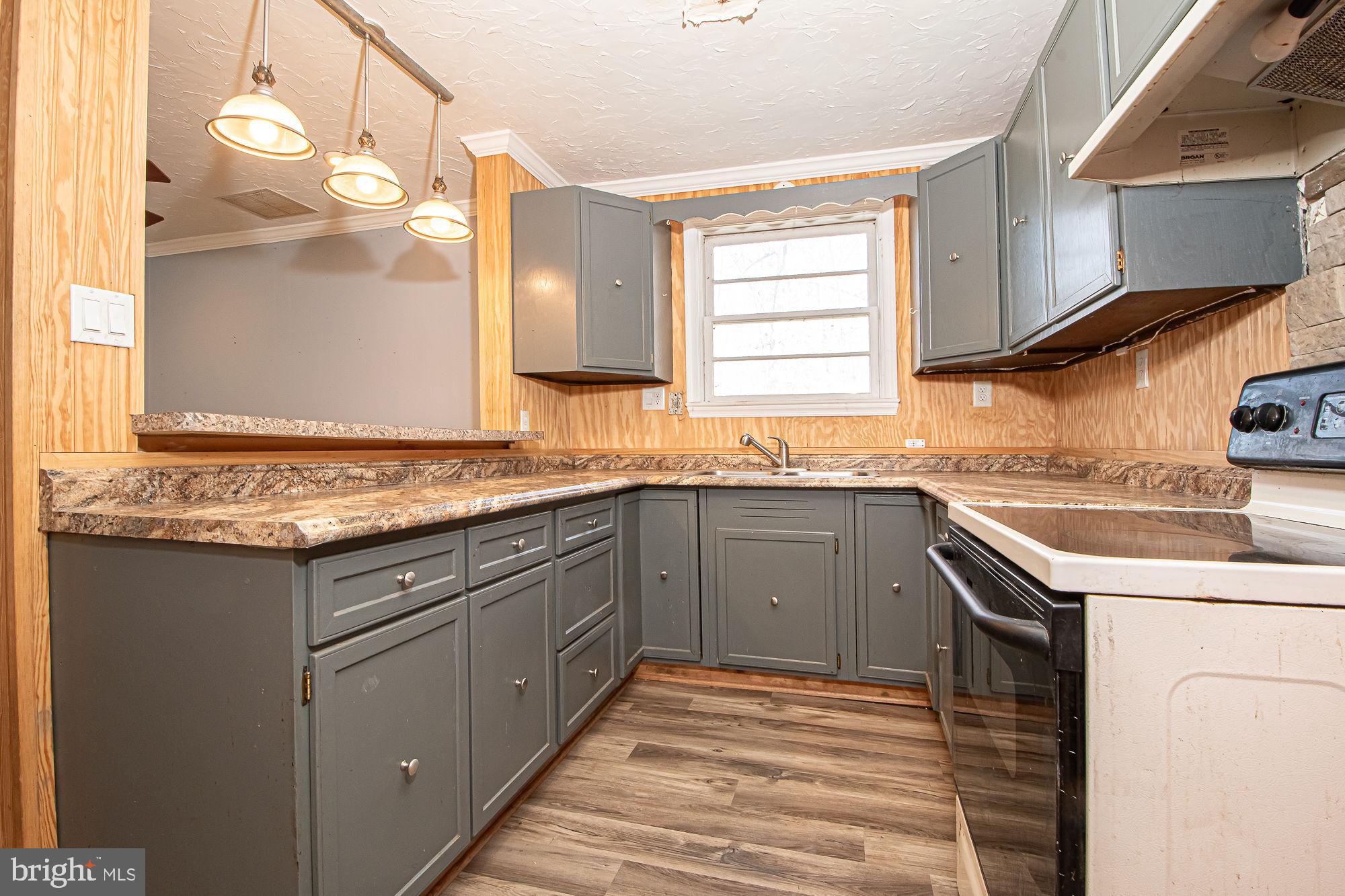 4792 Howellsville Road Front Royal, VA 22630 - Photo 22 of 41 a kitchen with granite countertop cabinets sink and window
