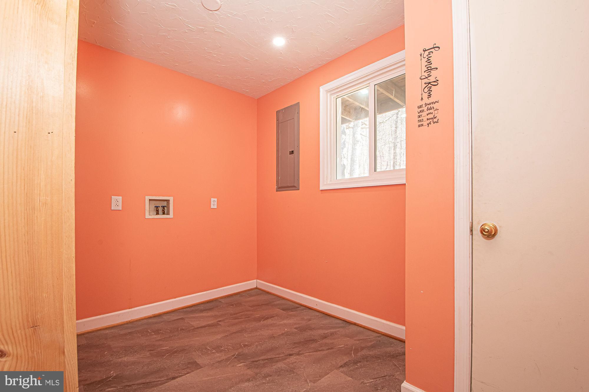 4792 Howellsville Road Front Royal, VA 22630 - Photo 24 of 41 a view of an empty room with wooden floor and a window