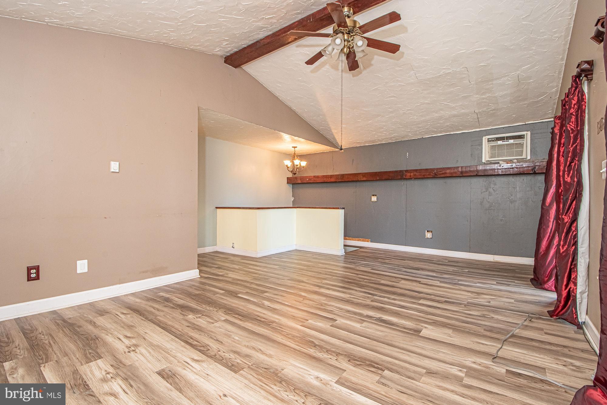 4792 Howellsville Road Front Royal, VA 22630 - Photo 29 of 41 a view of a bedroom with a bed and a chandelier fan