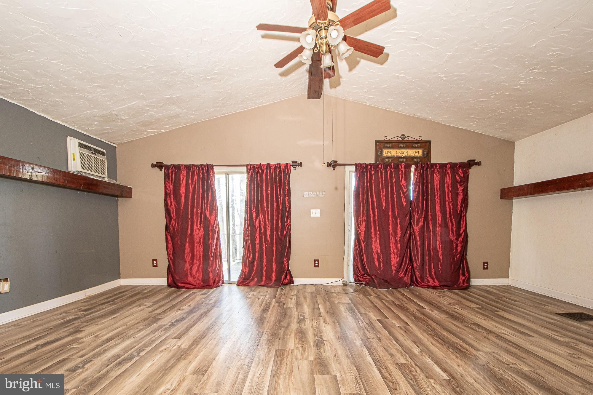 4792 Howellsville Road Front Royal, VA 22630 - Photo 30 of 41 a view of a livingroom with wooden floor and a ceiling fan