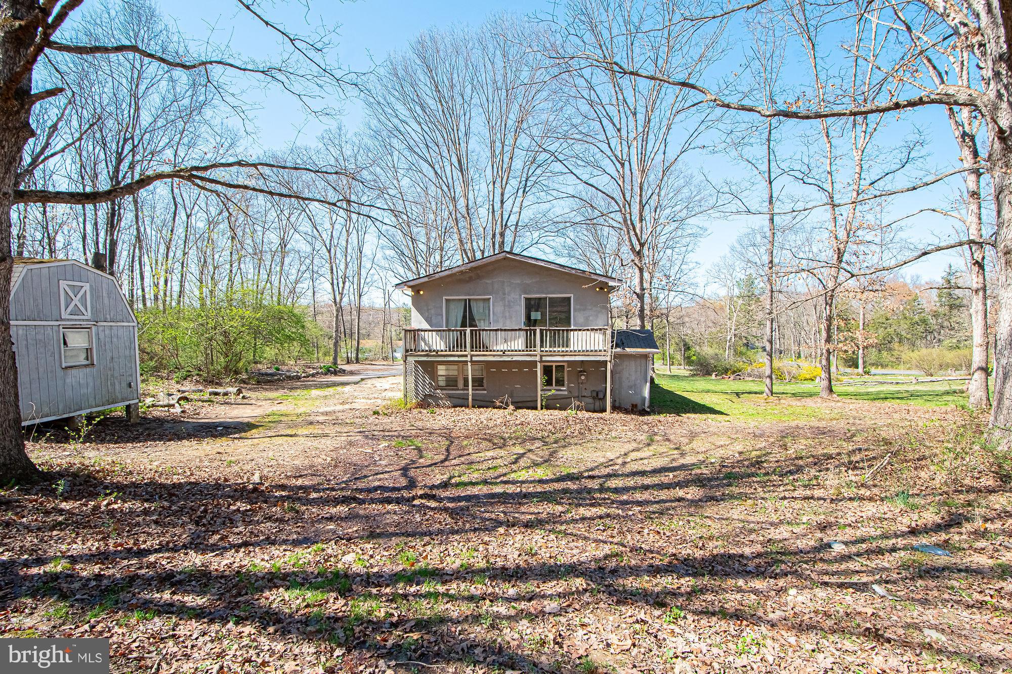 4792 Howellsville Road Front Royal, VA 22630 - Photo 40 of 41 a front view of a house with a yard and large trees