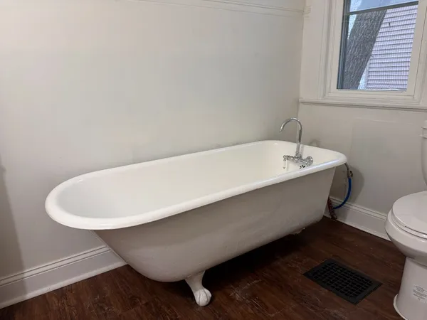 a bath tub sitting next to a white toilet