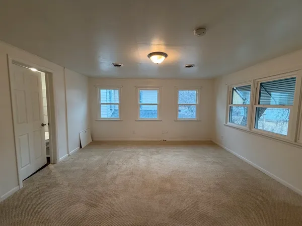 a view of an empty room with windows