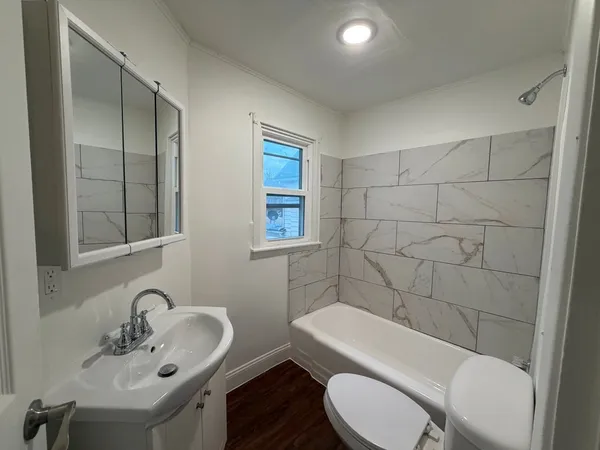 a bathroom with a sink mirror toilet and shower