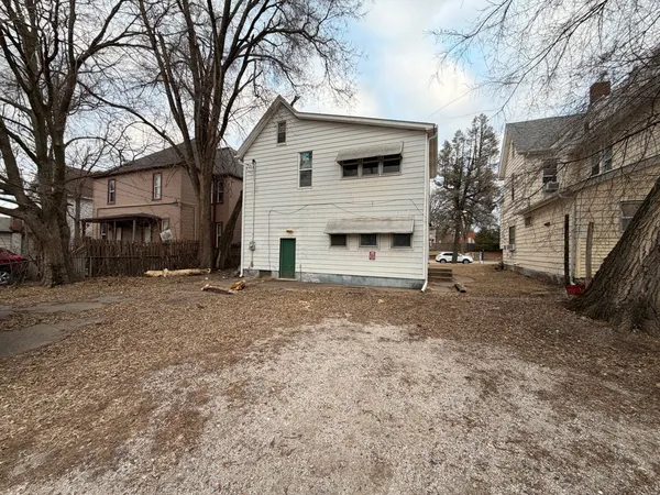 a view of a house with a yard and garage