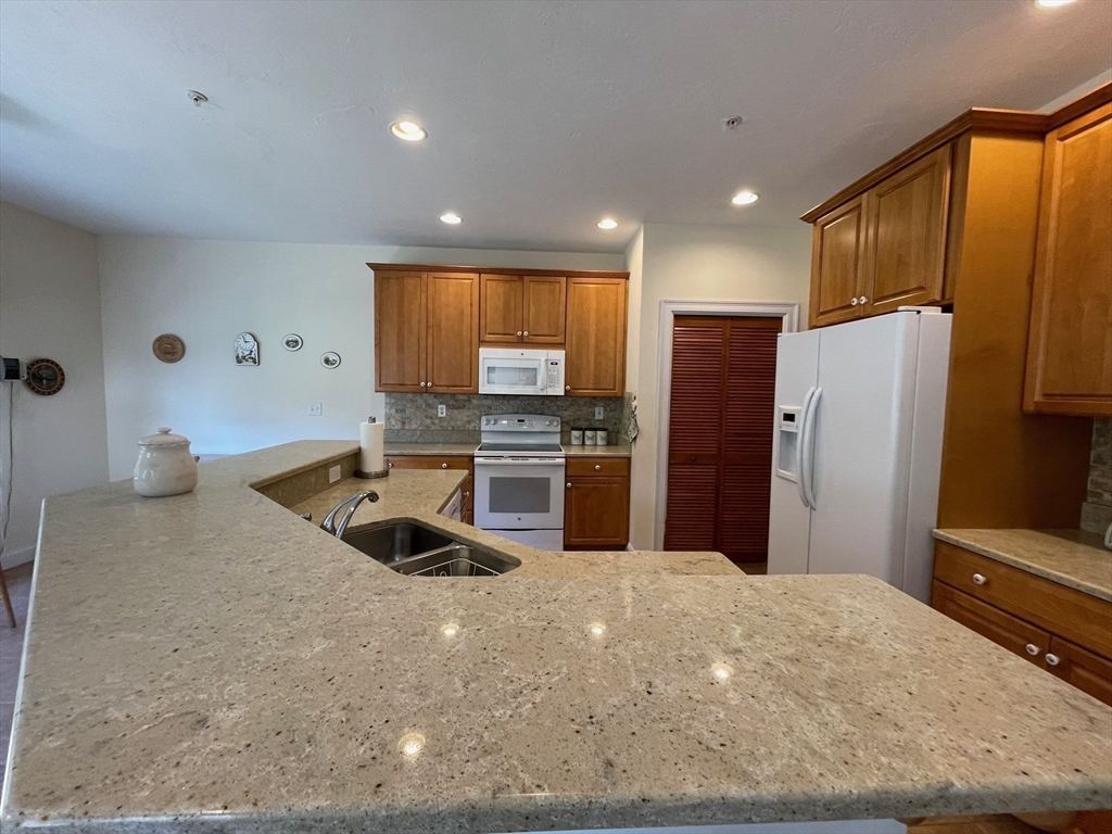7 Sandstone Road Westford, MA 01886 - Photo 11 of 29 a kitchen with stainless steel appliances a refrigerator sink and stove