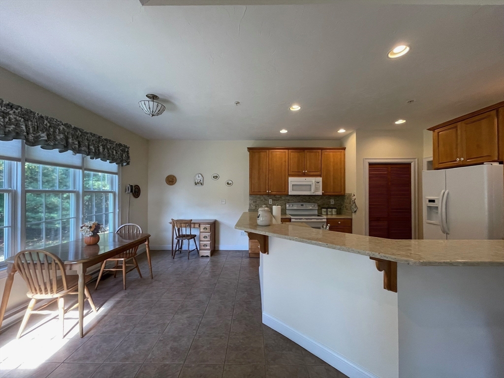 7 Sandstone Road Westford, MA 01886 - Photo 12 of 29 a living room with stainless steel appliances kitchen island furniture and a large window