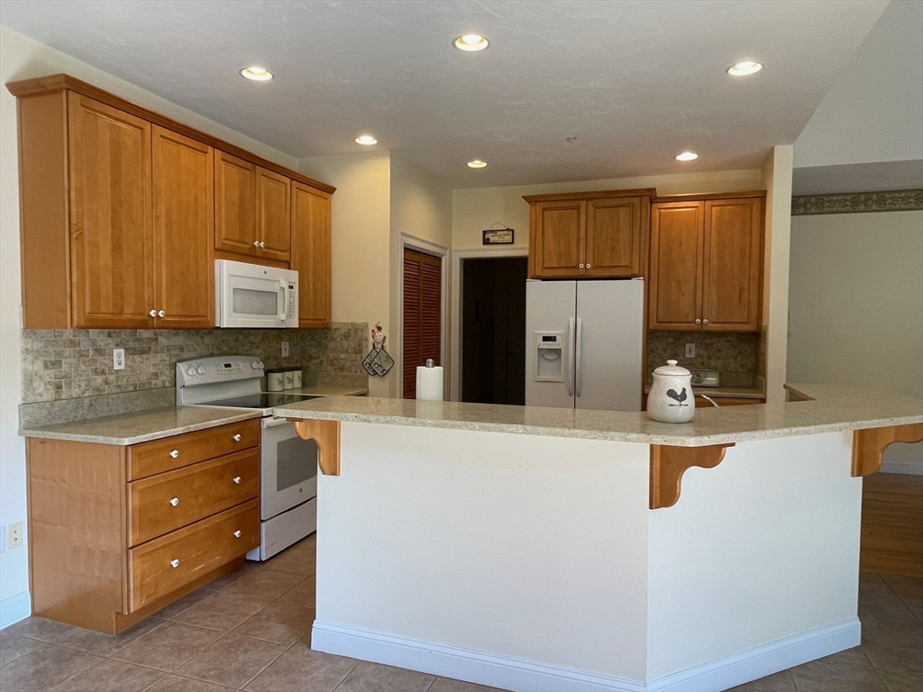 7 Sandstone Road Westford, MA 01886 - Photo 13 of 29 a kitchen with stainless steel appliances granite countertop a refrigerator and a stove