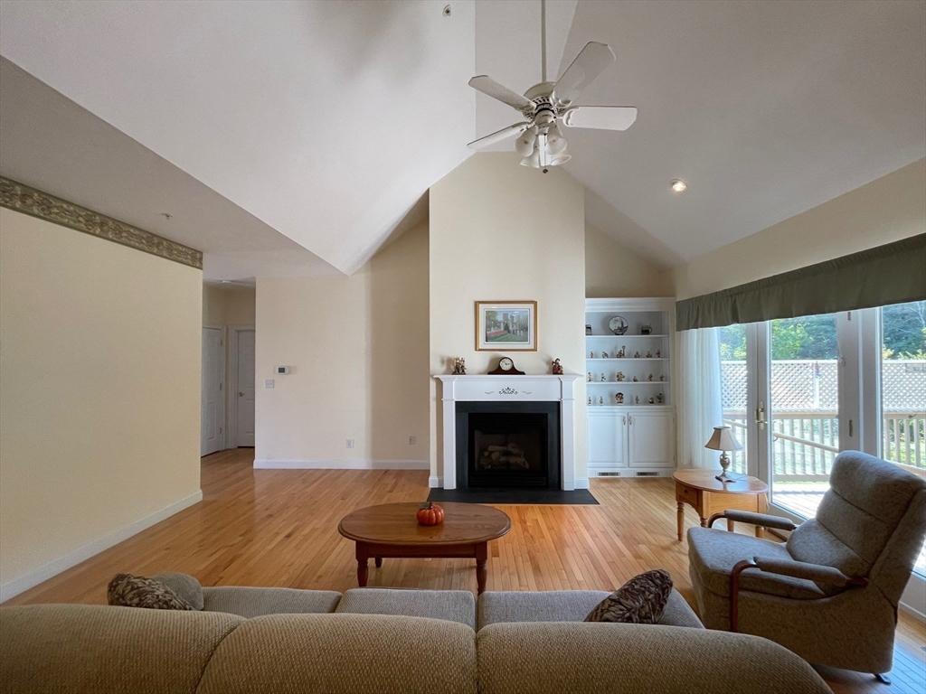 7 Sandstone Road Westford, MA 01886 - Photo 16 of 29 a living room with furniture and a fireplace