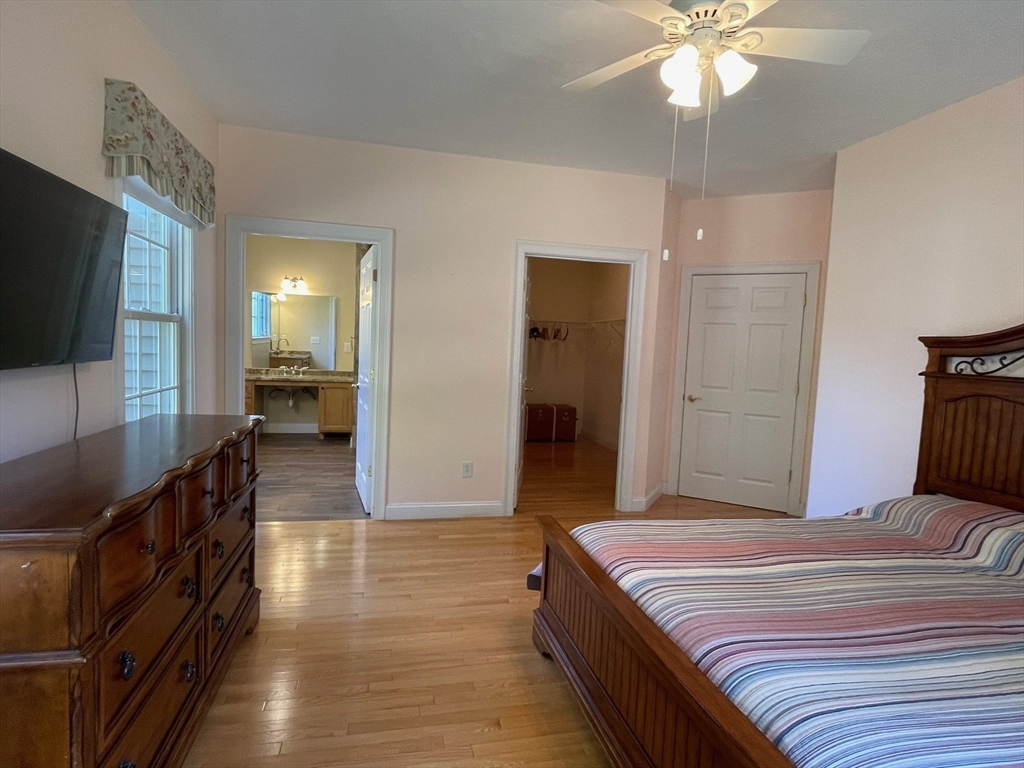 7 Sandstone Road Westford, MA 01886 - Photo 18 of 29 a bedroom with a bed and a chandelier