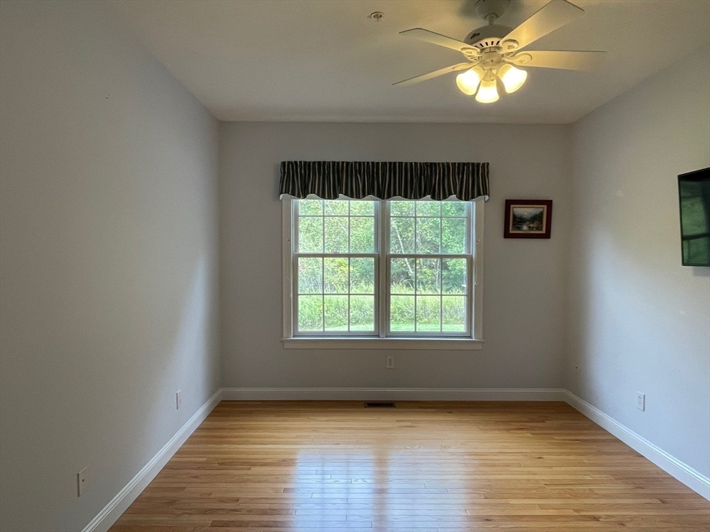 7 Sandstone Road Westford, MA 01886 - Photo 22 of 29 an empty room with wooden floor fan and windows