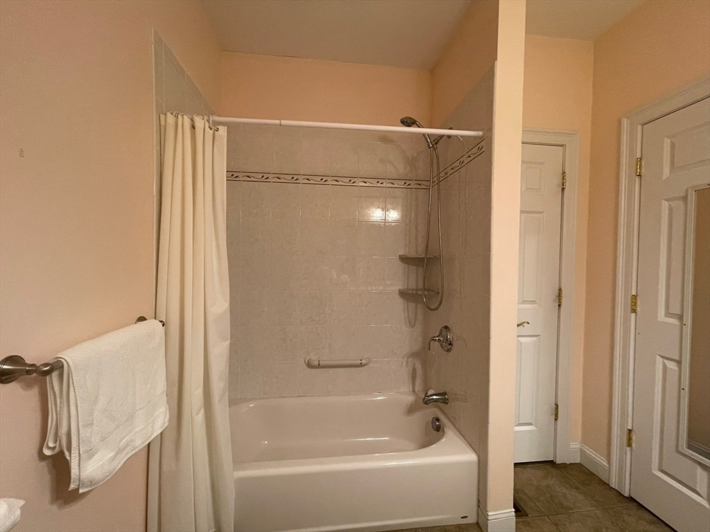 7 Sandstone Road Westford, MA 01886 - Photo 25 of 29 a bathroom with a bathtub and a shower