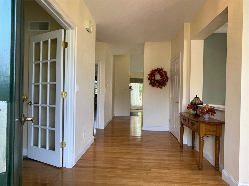 7 Sandstone Road Westford, MA 01886 - Photo 7 of 29 a view of a hallway view with wooden floor and furniture