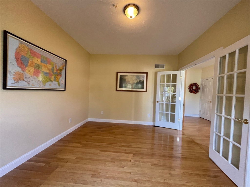 7 Sandstone Road Westford, MA 01886 - Photo 8 of 29 a view of an empty room with wooden floor and a window