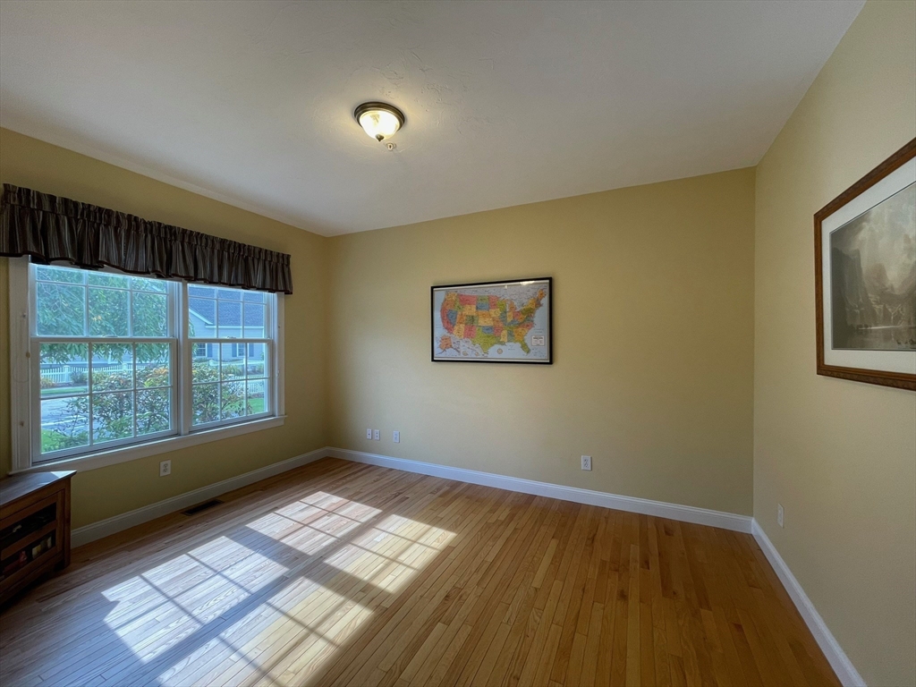 7 Sandstone Road Westford, MA 01886 - Photo 9 of 29 a view of empty room with wooden floor and fan