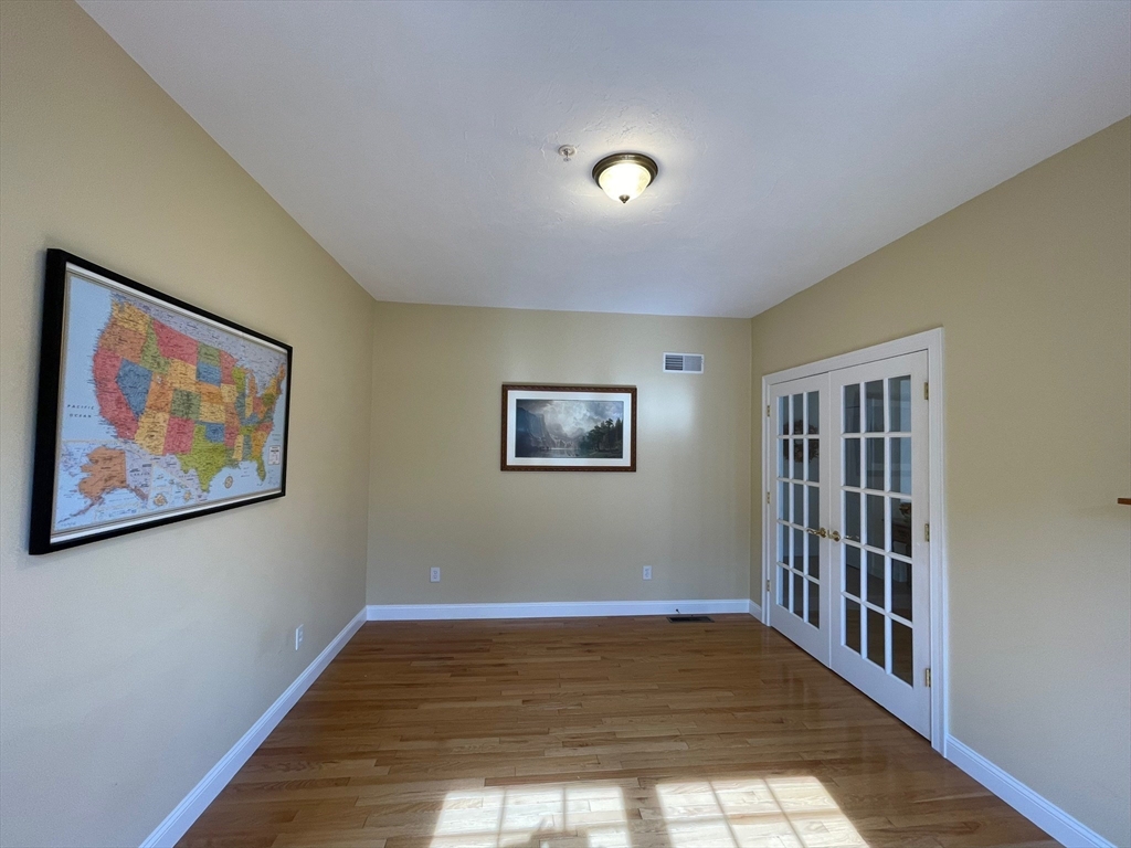 7 Sandstone Road Westford, MA 01886 - Photo 10 of 29 a view of an empty room with wooden floor and window