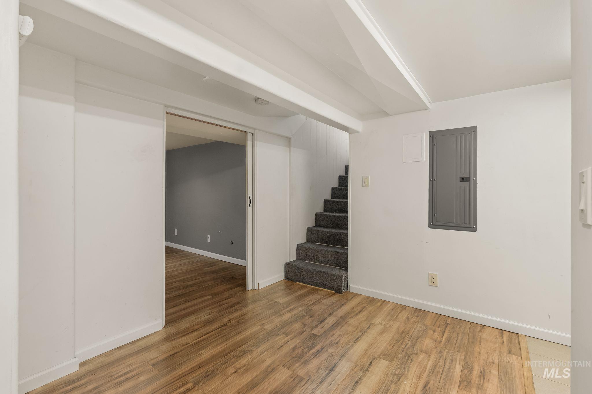 928 3rd Street Clarkston, WA 99403 - Photo 33 of 44 Hardwood-finish flooring extending into a separate room, with a staircase featuring dark carpeting