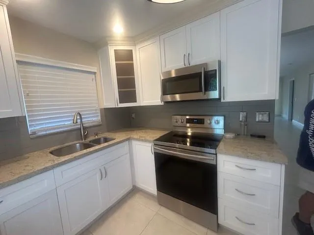 a stove top oven sitting inside of a kitchen