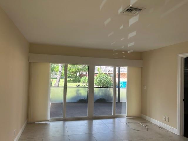 2821 Southeast 5th Circle Boynton Beach, FL 33435 - Photo 7 of 38 an empty room with wooden floor and windows