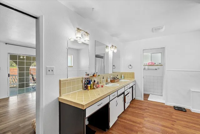 a kitchen with stainless steel appliances granite countertop a sink a stove a refrigerator and cabinets