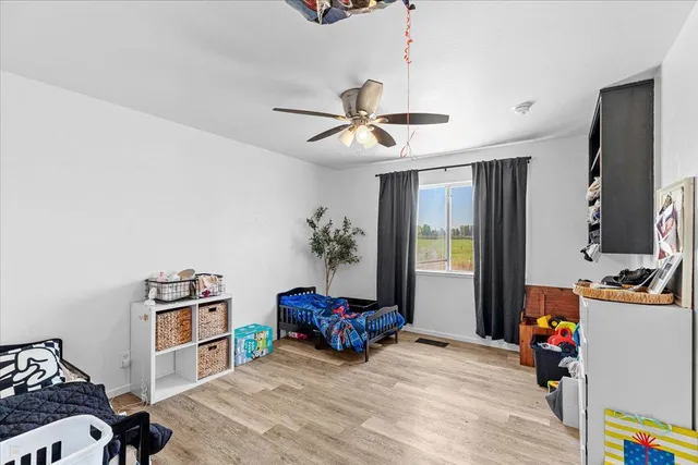 a kitchen with stainless steel appliances granite countertop a sink dishwasher stove and refrigerator with wooden floor