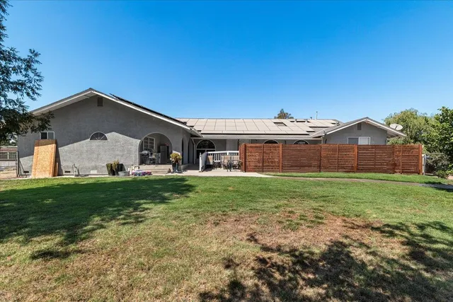 a view of a house with backyard sitting area and slide