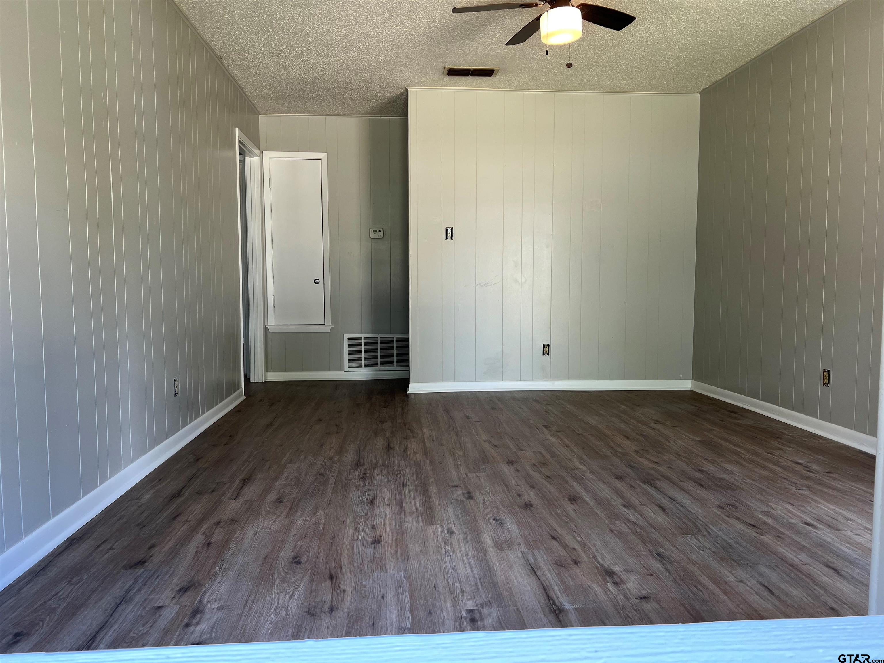 3161 Glenda Avenue, Unit 202 Tyler, TX 75704 - Photo 2 of 13 a view of an empty room with wooden floor