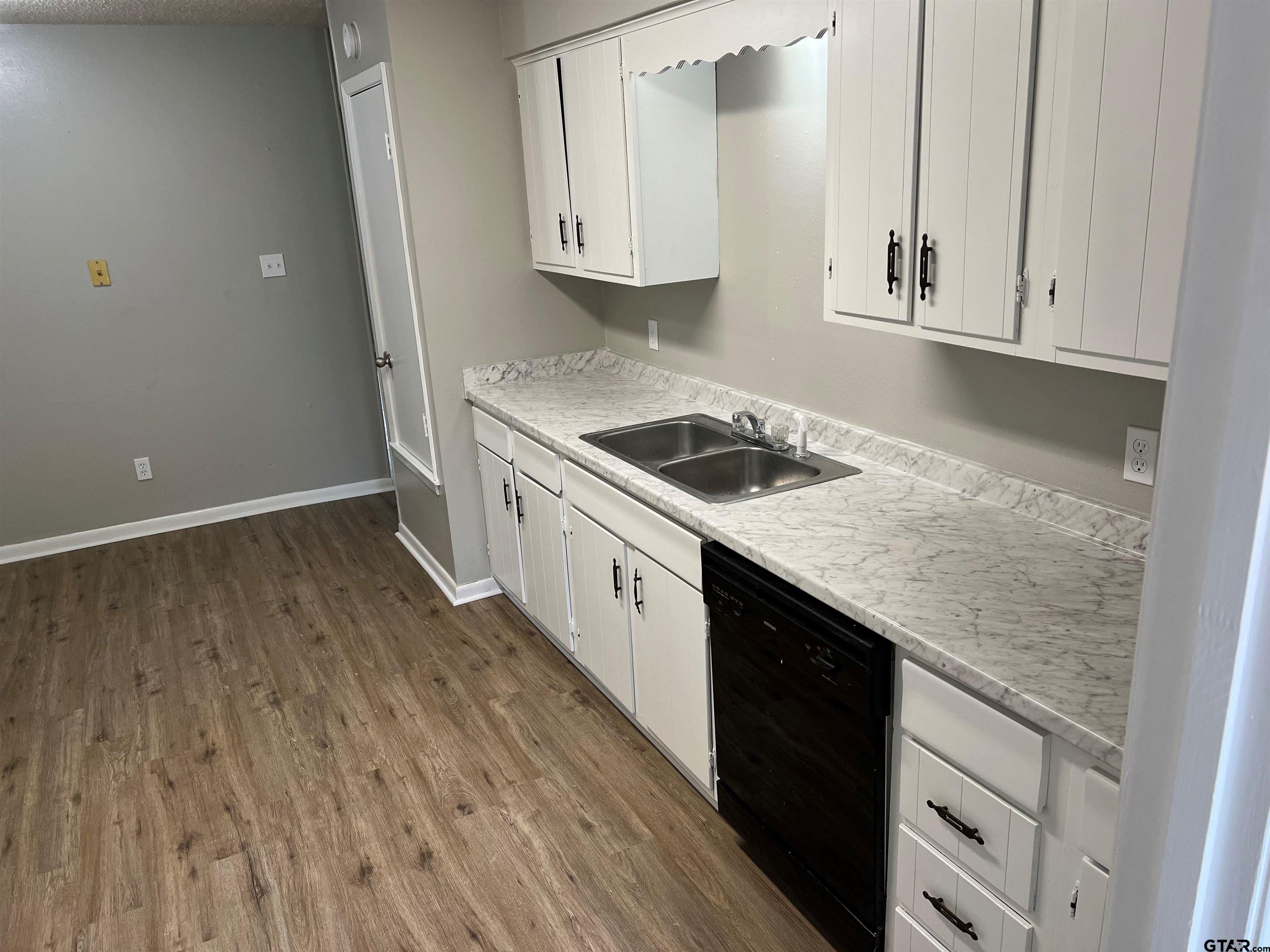 3161 Glenda Avenue, Unit 202 Tyler, TX 75704 - Photo 6 of 13 an empty room with wooden floor washer and dryer