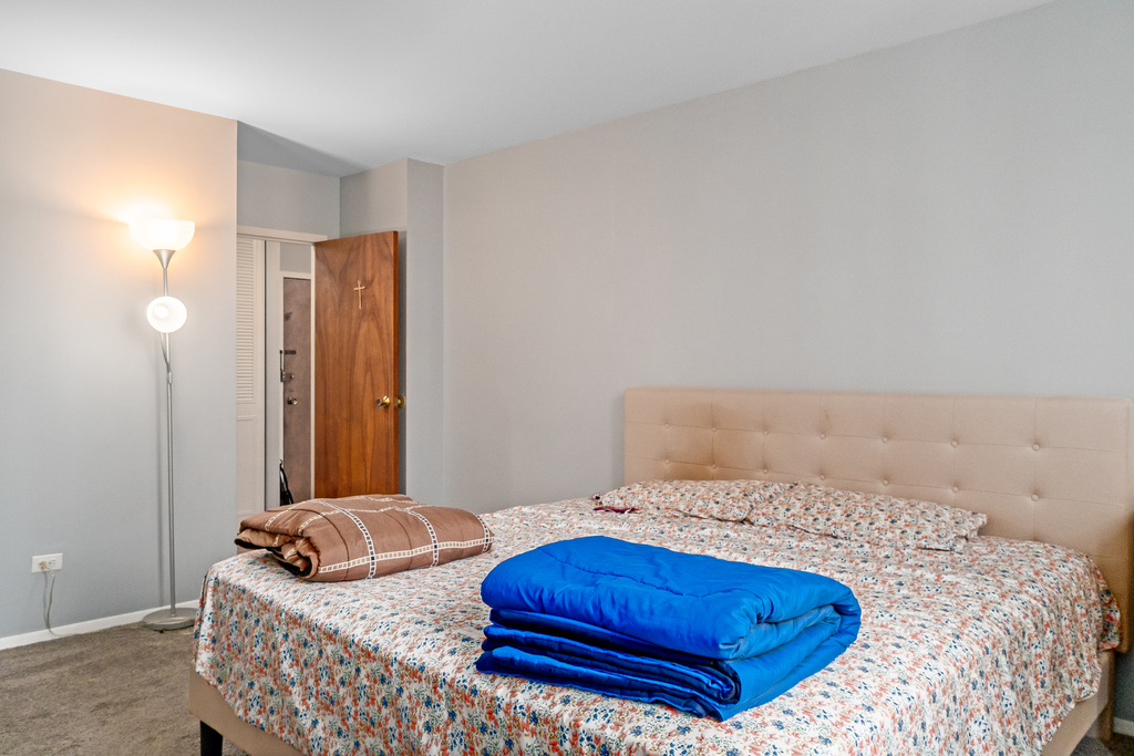 9001 Golf Road, Unit 4D Des Plaines, IL 60016 - Photo 12 of 15 a bedroom with a bed and dresser