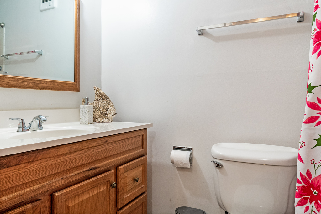 9001 Golf Road, Unit 4D Des Plaines, IL 60016 - Photo 13 of 15 a bathroom with a sink vanity mirror and toilet