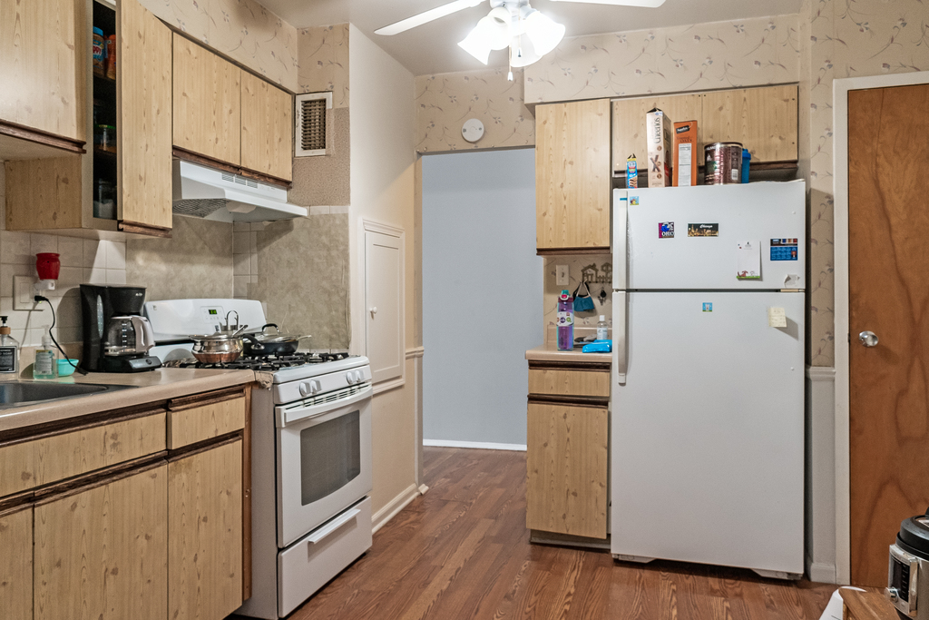 9001 Golf Road, Unit 4D Des Plaines, IL 60016 - Photo 8 of 15 a white refrigerator freezer sitting inside of a kitchen