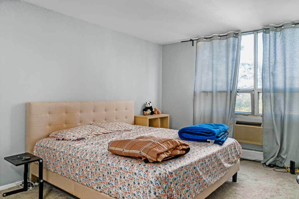 9001 Golf Road, Unit 4D Des Plaines, IL 60016 - Photo 10 of 15 a bedroom with a bed and a window