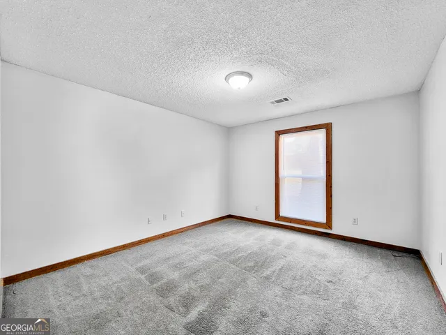 an empty room with a empty space and window