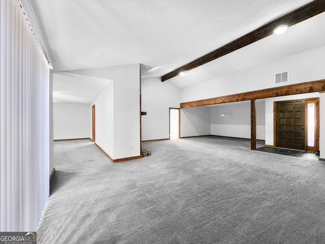 a view of an empty room with windows