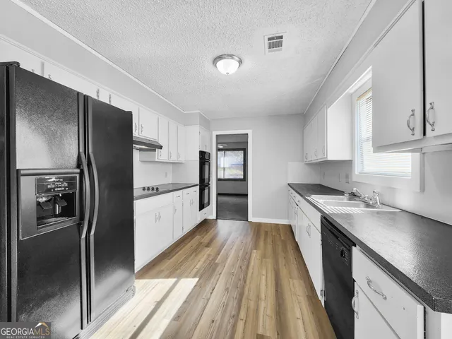 a kitchen with a refrigerator and a sink