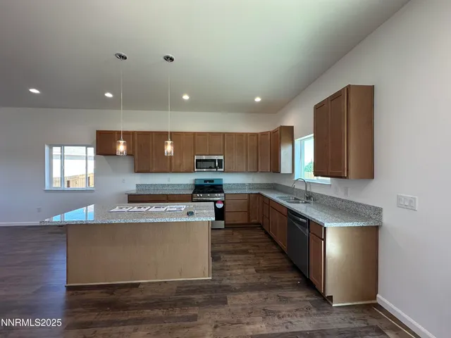 a large kitchen with stainless steel appliances granite countertop a large counter top and a stove