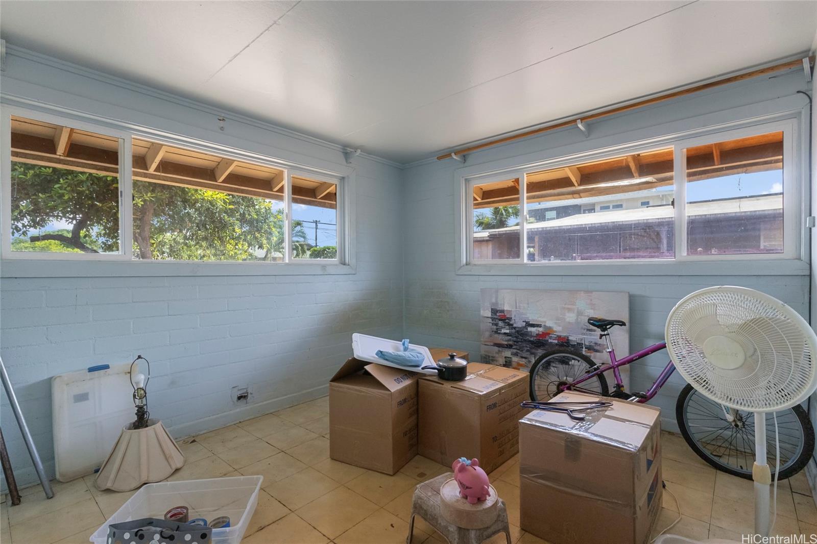 1238 Molehu Drive Honolulu, HI 96818 - Photo 15 of 25 a room with furniture a window and flowerpot