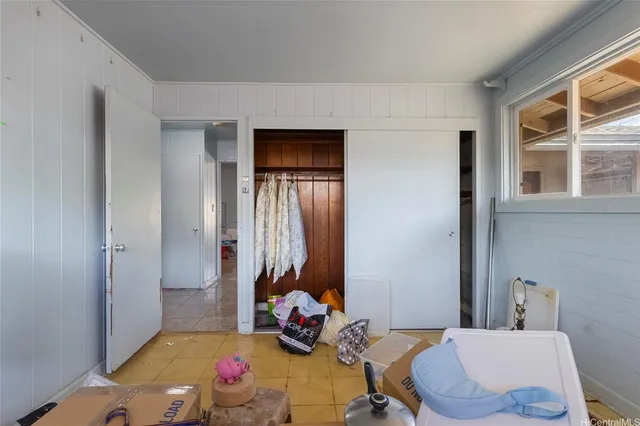 a bedroom with bed and a window