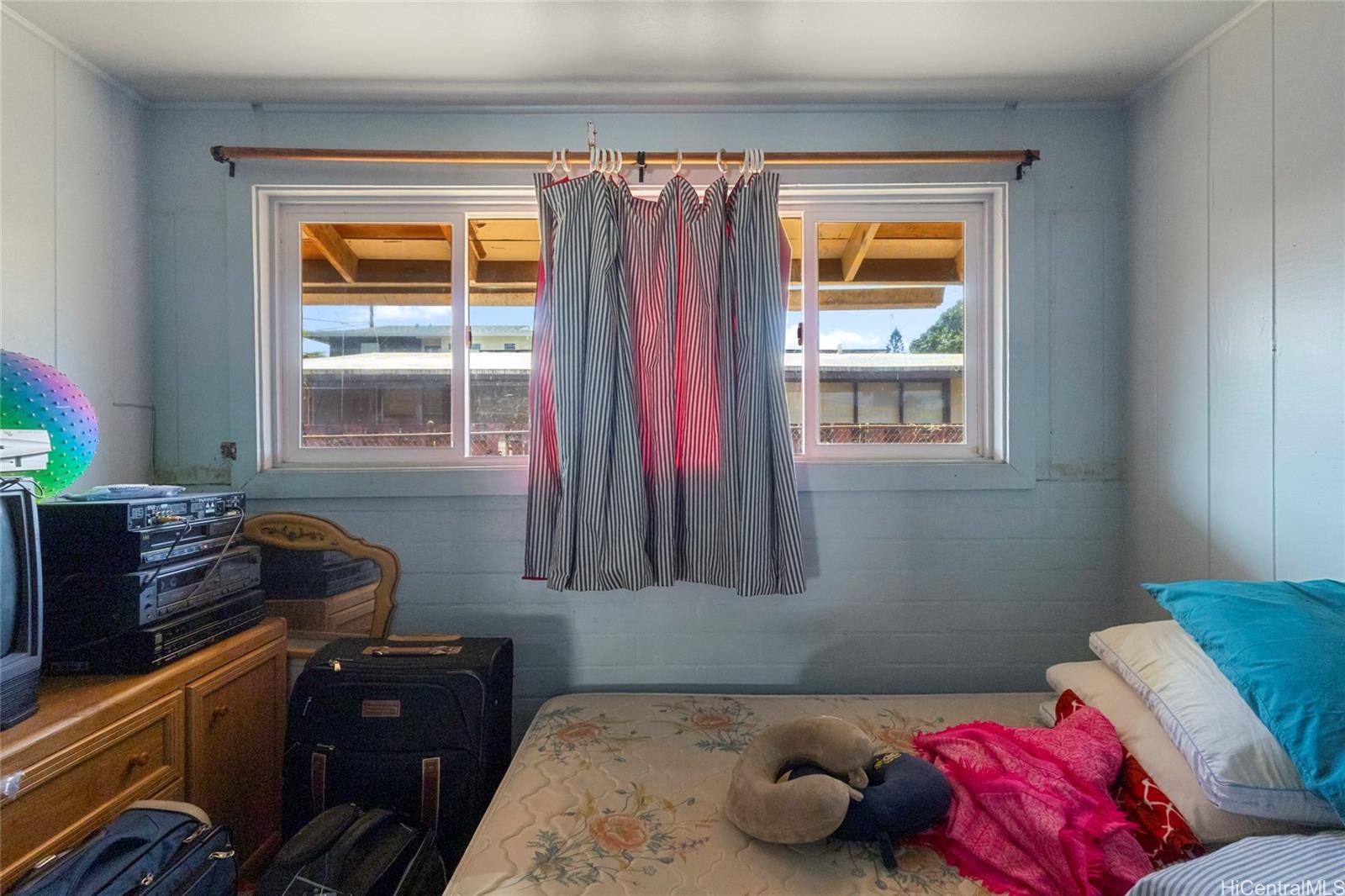 1238 Molehu Drive Honolulu, HI 96818 - Photo 18 of 25 a bedroom with a bed and a window