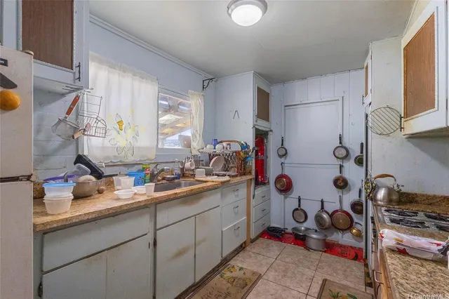 a kitchen with stainless steel appliances a sink and a refrigerator