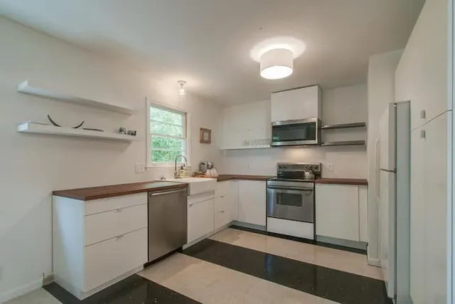 a view of a a dining room with furniture window and wooden floor