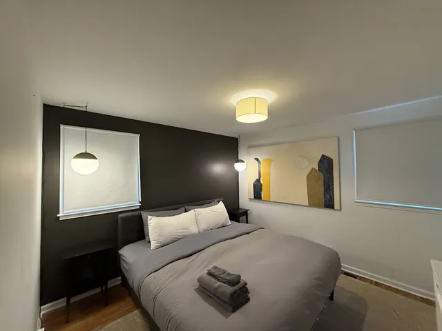 a bedroom with a bed and a table