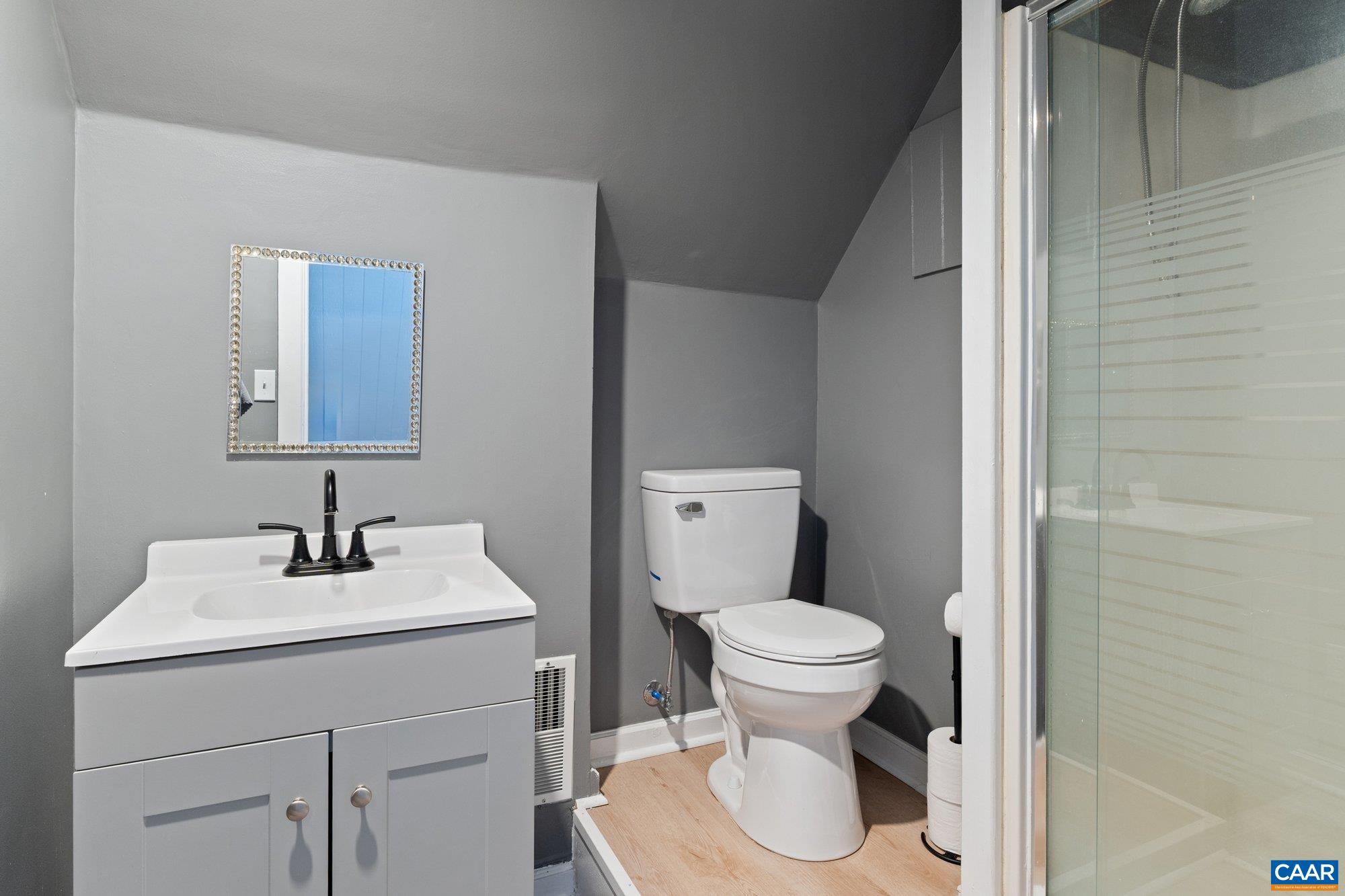 14910 Western Mill Road Lawrenceville, VA 23868 - Photo 49 of 73 a bathroom with a sink toilet and mirror